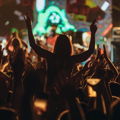silhouette-of-a-woman-with-raised-hands-on-a-concert.jpg